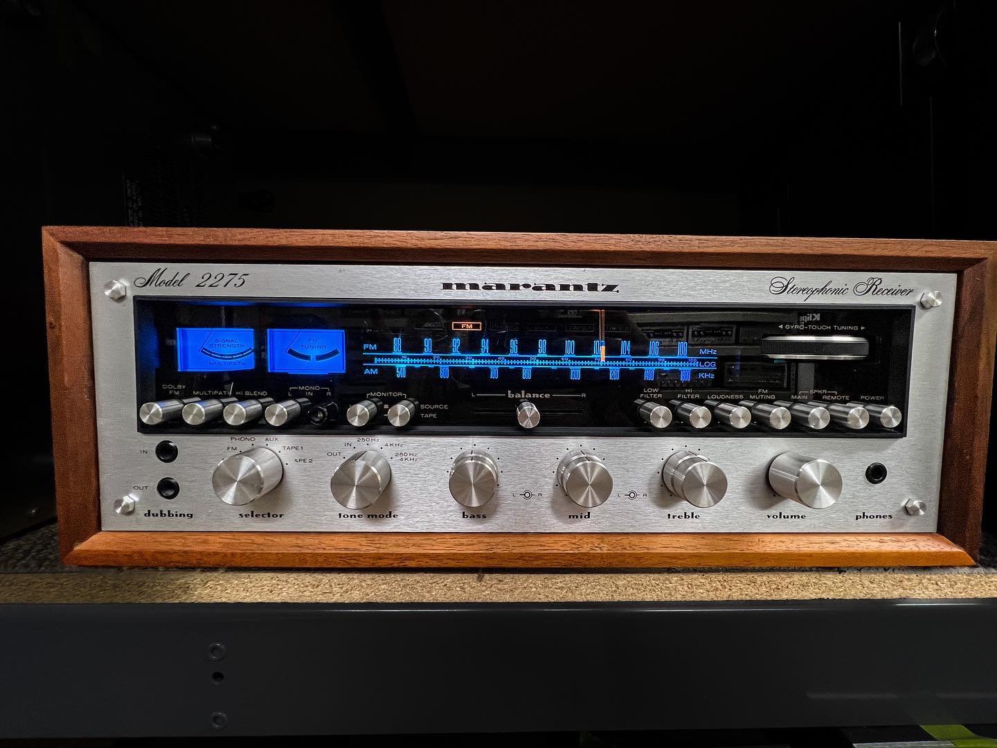 A Marantz 2275 receiver at Speakerworks, with a walnut cabinet, brushed aluminum controls and a glowing blue dial.